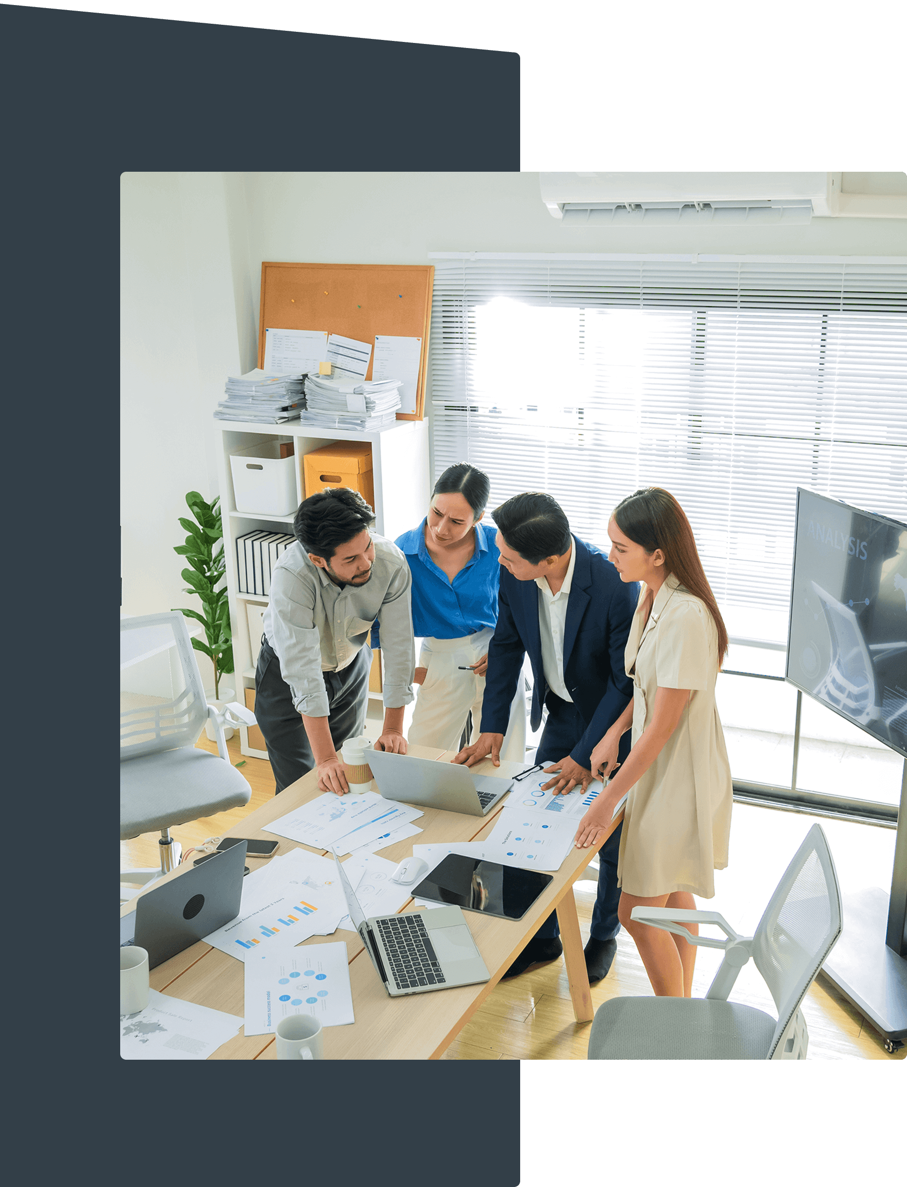 People collaborating around a table with documents.